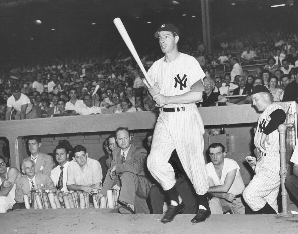 FILE - Joe DiMaggio (5), former New York Yankees baseball great, hits a  single in the New York Mets' Old Timers' Game at Shea Stadium in New York  on July 31, 1971