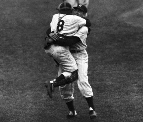 New York Yankees' catcher Yogi Berra leaps into the arms of pitcher Don Larsen after Larsen struck out the last Brooklyn Dodgers' batter to complete his perfect game during the fifth game of the World Series, Oct. 8, 1956. Racing up in the background is Joe Collins. (AP Photo)